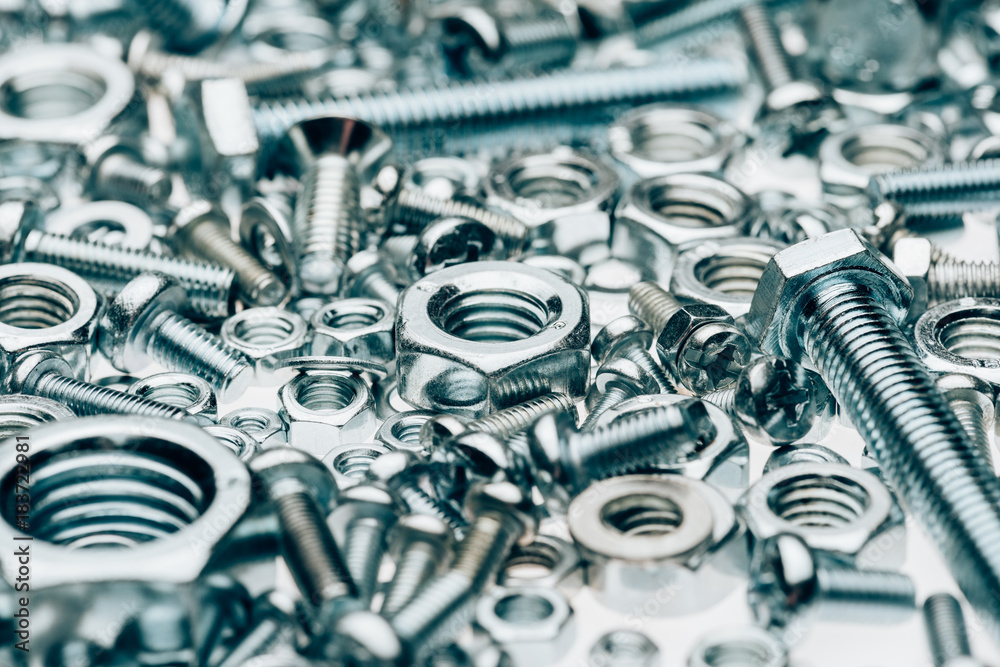 close up view of metal framing nails and capscrews isolated on white close up view of metal framing nails and capscrews isolated on white