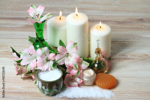 Spa concept, candles, flower, body cream, bath crystals, soap, perfume 