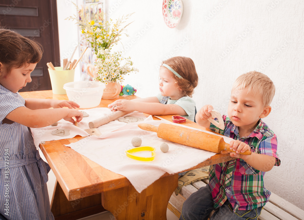 Happy children are engaged with modeling clay Happy children are engaged with modeling clay
