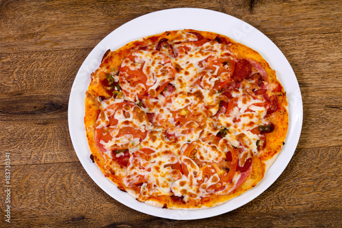 Pizza with sausages and tomato
