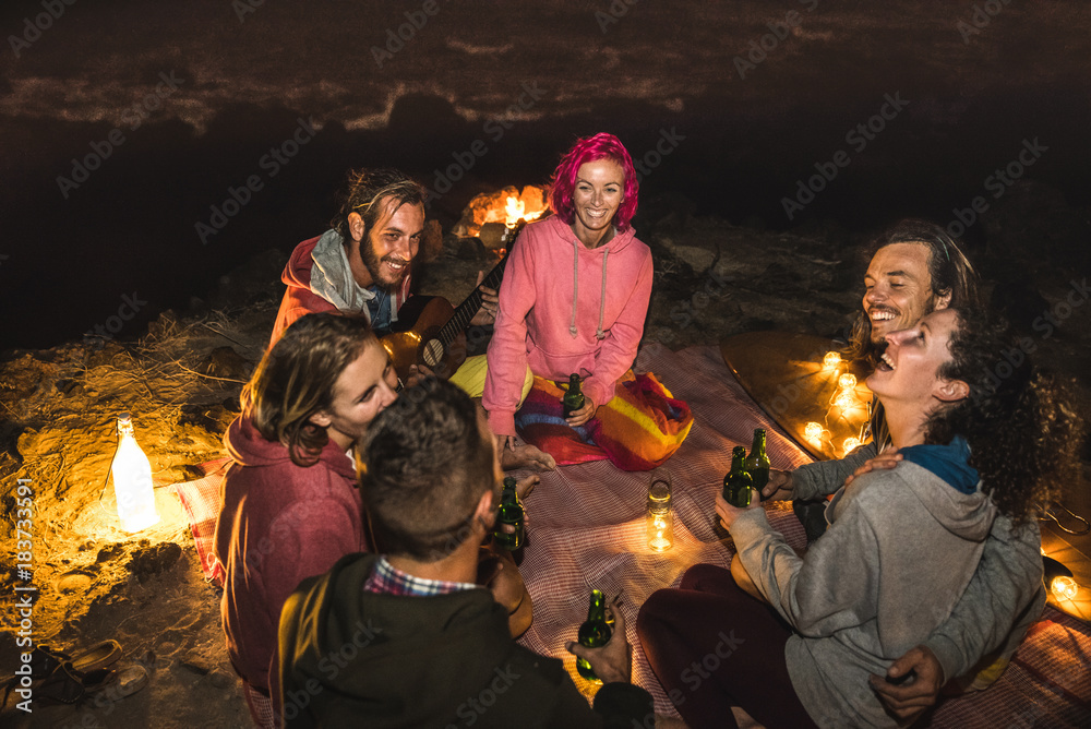 Young Hipster Friends Having Fun Together At Beach Camping Party By Night With Campfire Light Friendship Travel Concept With Young People Traveler Drinking Beer At Summer Surf Bonfire High Iso Image Stock Young Hipster Friends Having Fun Together At Beach Camping Party By Night With Campfire Light Friendship Travel Concept With Young People Traveler Drinking Beer At Summer Surf Bonfire High Iso Image Stock