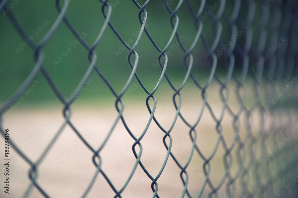 Abstract blurry outside wire fence background. Selective focus used. Abstract blurry outside wire fence background. Selective focus used.