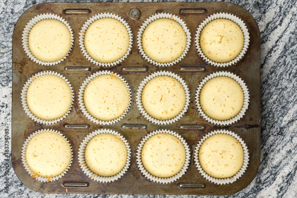 Raw vanilla cupcake muffins ready for baking Raw vanilla cupcake muffins ready for baking