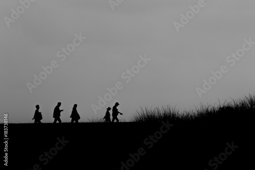 family walking silhouette horizon black and white © Adam