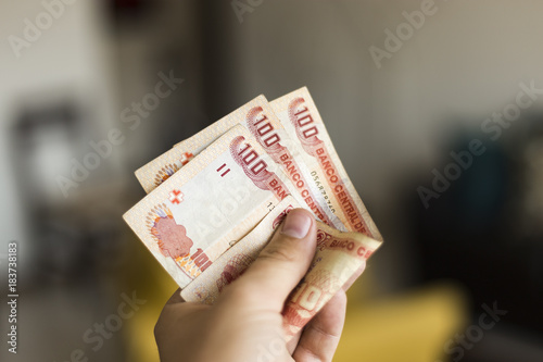 300 Bolivianos In Hand photo