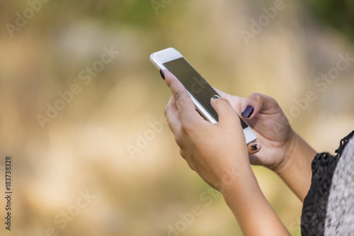 Girl's Hands Holding White Cellphone