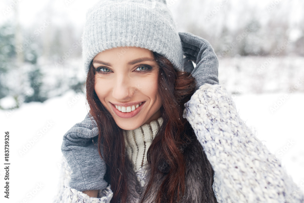 beautiful smiling young woman in wintertime outdoor. Winter concept