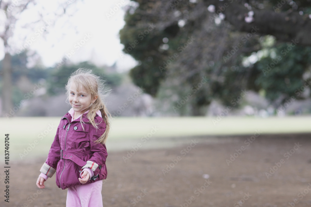 Portrait of a blond girl in beautiful clothes for a walk in the park Portrait of a blond girl in beautiful clothes for a walk in the park