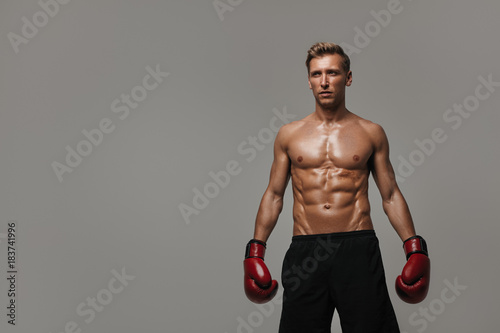 Muscular sportsman in boxing gloves © kegfire