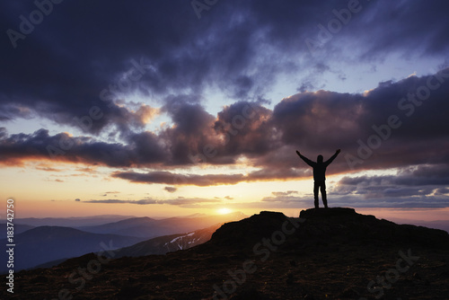 Silhouette of man praying over beautiful sky background