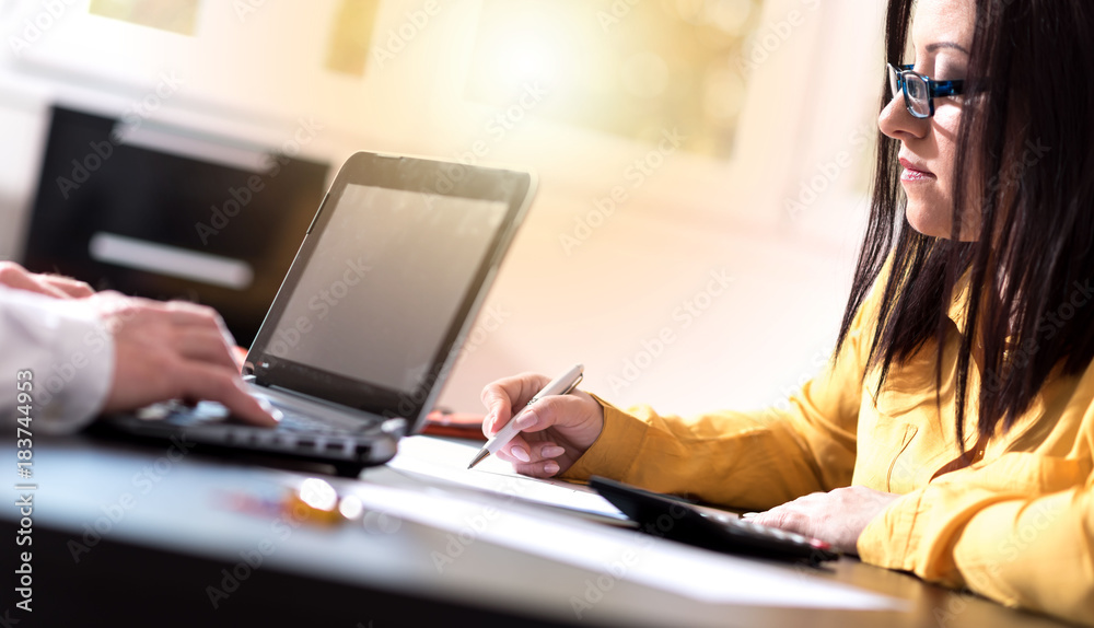 Young businesswoman working on documents, light effect Young businesswoman working on documents, light effect