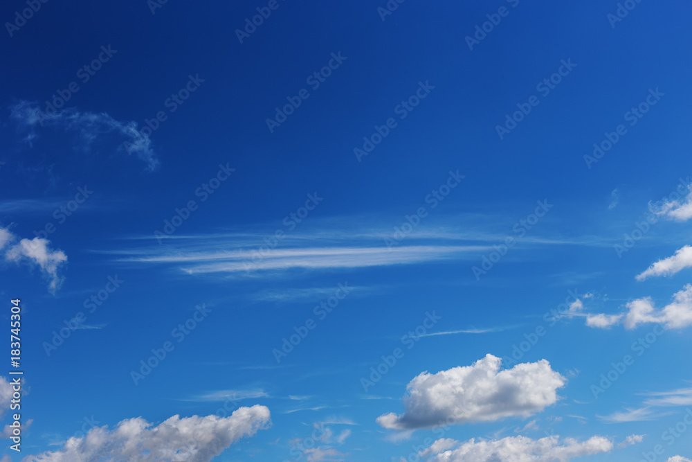 Cumulus and Cirrus clouds in the blue sky as the background