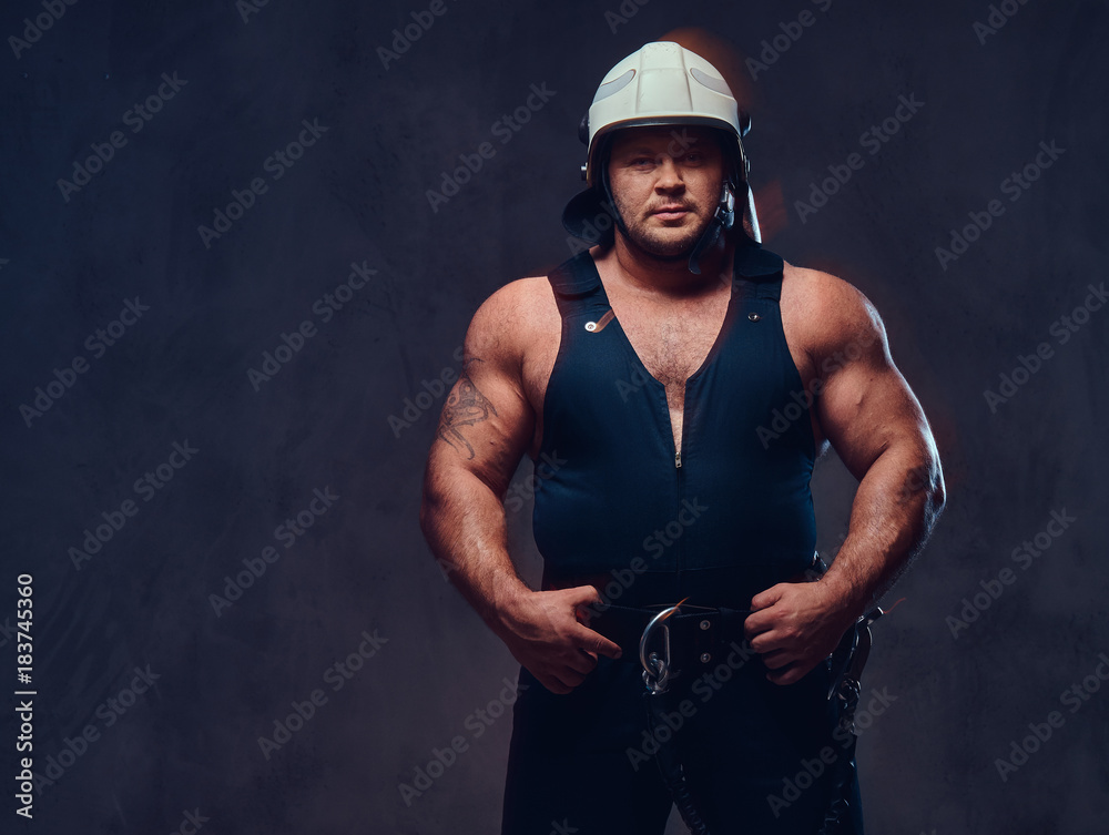 Brutal firefighter dressed in underwear waistcoat.