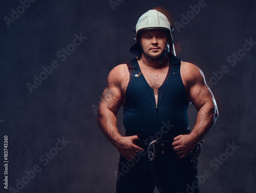 Brutal firefighter dressed in underwear waistcoat.