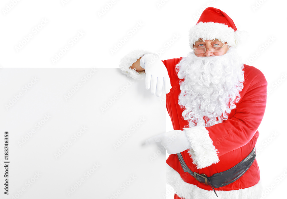 Santa Claus pointing in white blank sign with smile, isolated on white background Santa Claus pointing in white blank sign with smile, isolated on white background