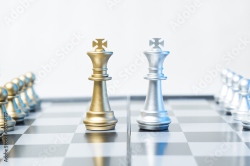 A conceptual photo with chess pieces on a chessboard. Business, law or political concept, which could represent war of corporations, geopolitical situation and so on. Selective focus.
