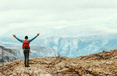 Traveling Man enjoying Norway mountains view Travel Lifestyle concept adventure active summer vacations outdoor hiking sport with red backpack