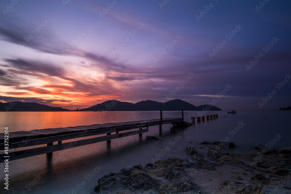 Beautiful view of sunset at Lumut,Perak,Malaysia. Soft focus,motion blur due to Long Exposure.Visible noise due to High ISO.