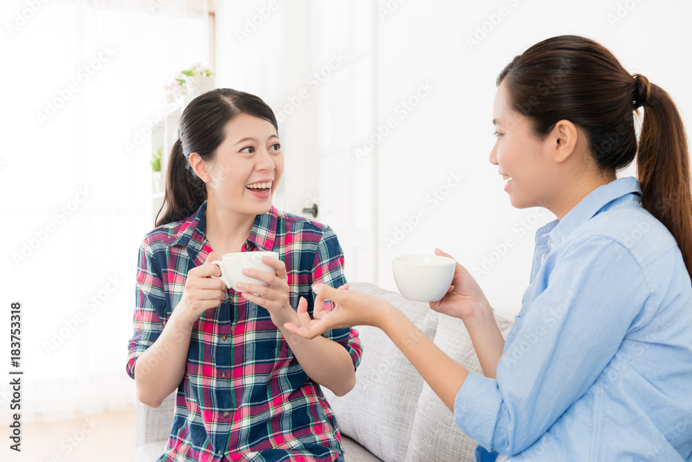 cheerful pretty sisters sitting on sofa couch cheerful pretty sisters sitting on sofa couch