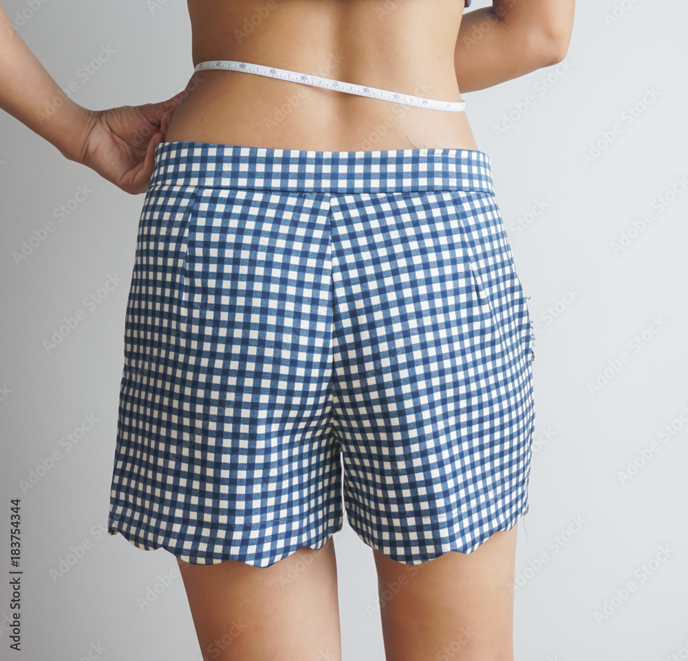 Slim body of asian woman with a measuring tape on white background. Slim body of asian woman with a measuring tape on white background.