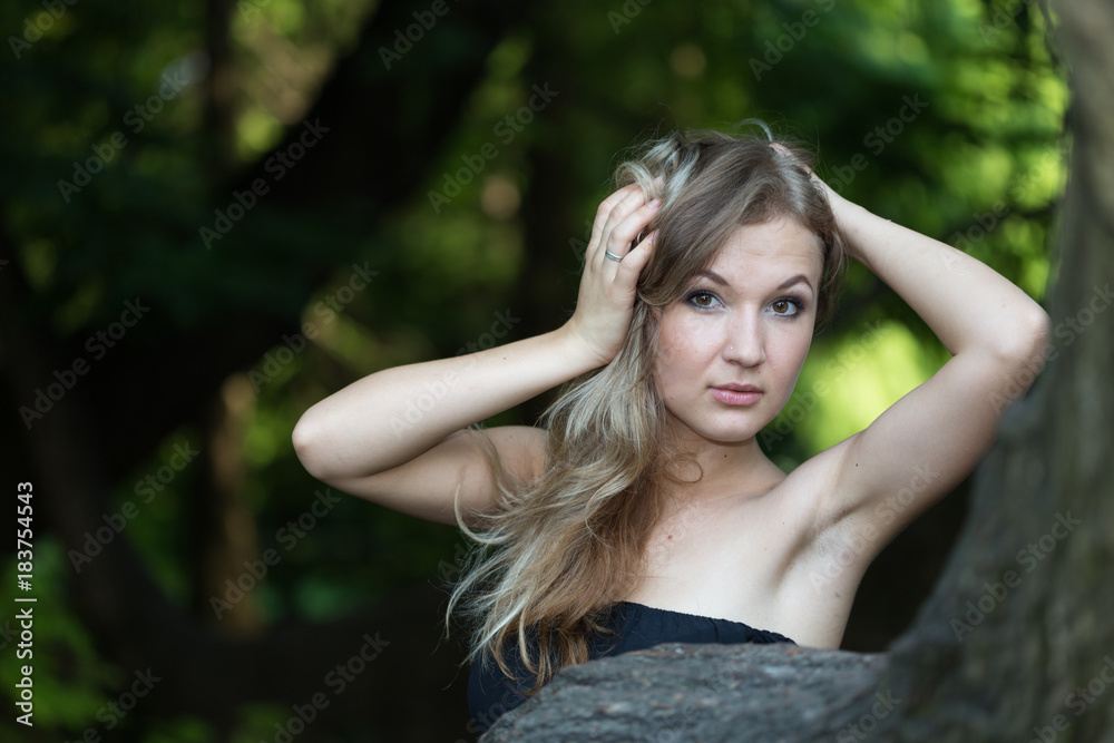 Beautiful girl in black dress smooth her hair Beautiful girl in black dress smooth her hair