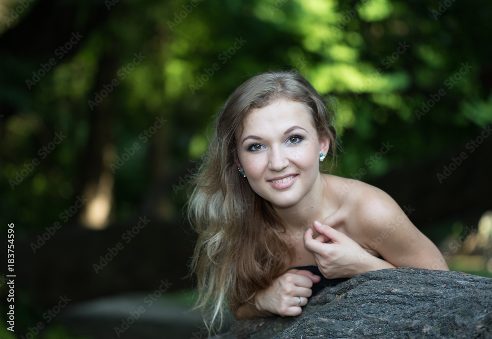 Beautiful girl in ball gown at tree and smiling Beautiful girl in ball gown at tree and smiling