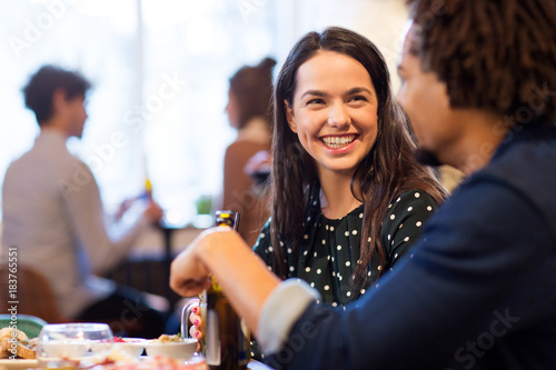 happy couple with drinks at restaurant or bar