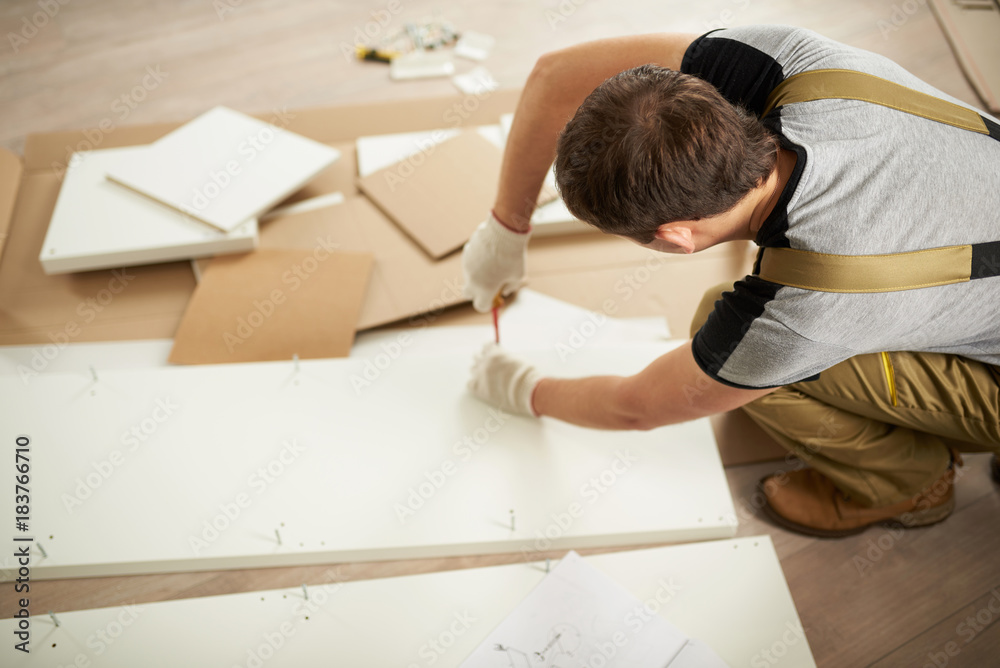 Man assembling furniture Man assembling furniture
