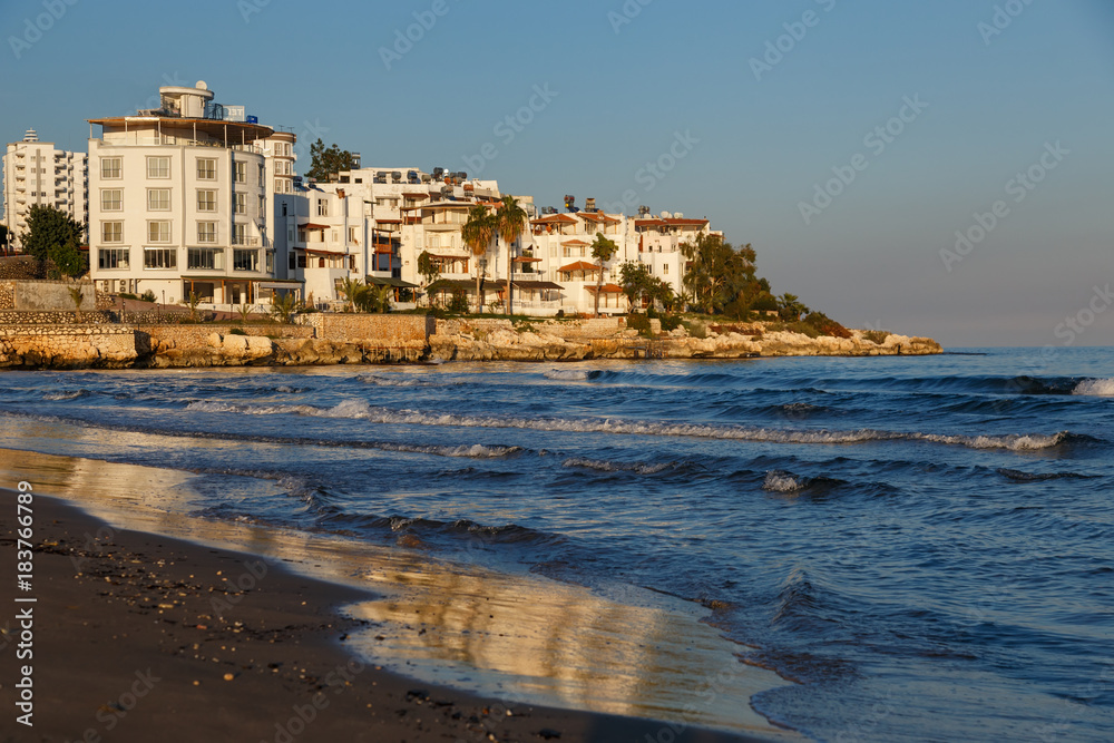 Seashore with buildings and waves