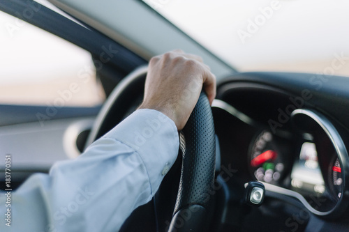 man hands holding steering wheel to drive © clementetinin