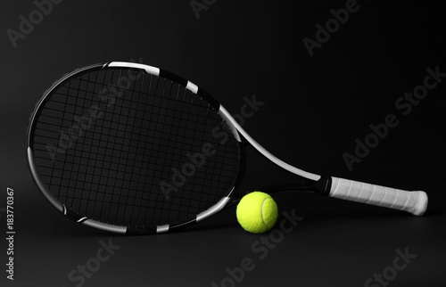 Tennis racket and ball on dark background © Africa Studio