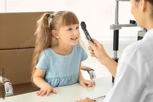 Ophthalmologist inspecting ...