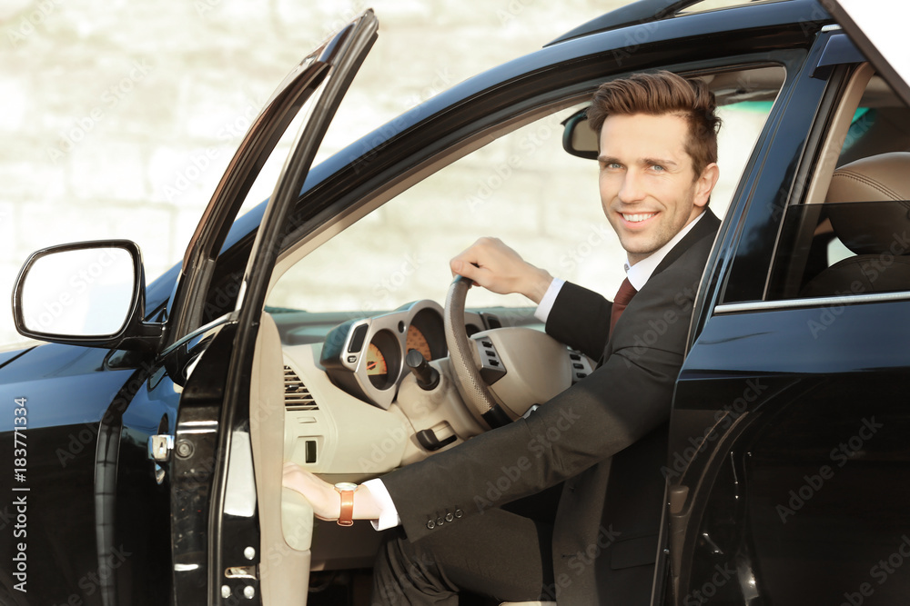 Man in formal wear getting out of car Man in formal wear getting out of car