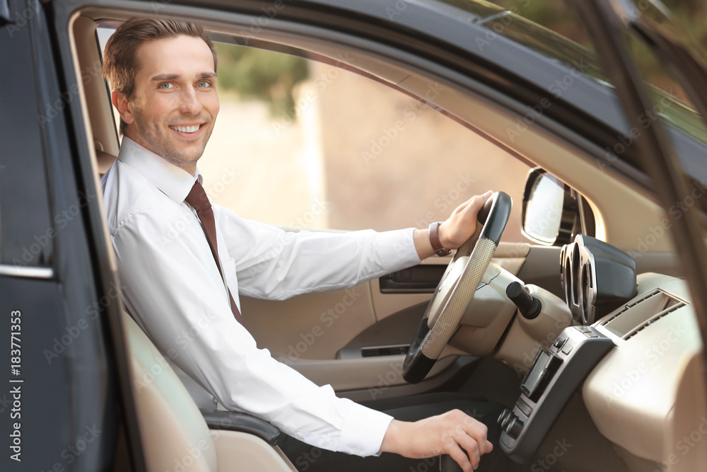 Businessman in driver's seat of car