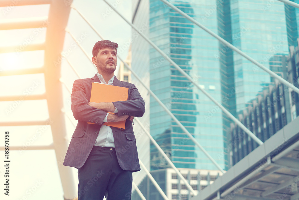 Handsome business man holding document. Concept of business work thinking. Handsome business man holding document. Concept of business work thinking.