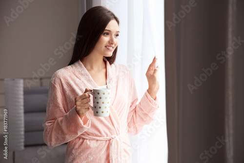 Young woman drinking coffee...