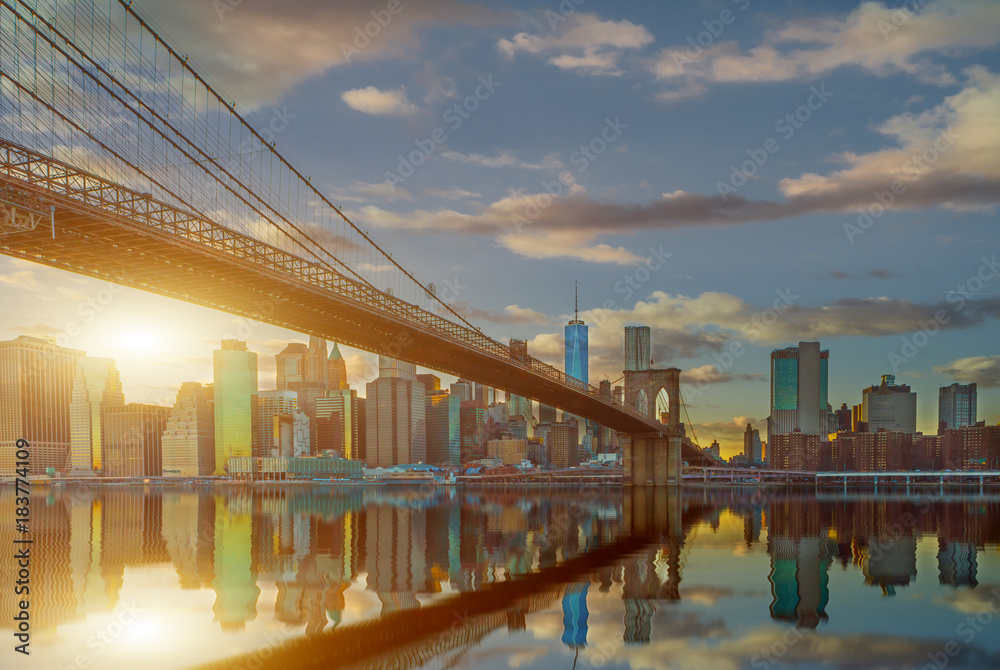 New York City Panoramic landscape view of Manhattan with famous Brooklyn Bridge at dusk .