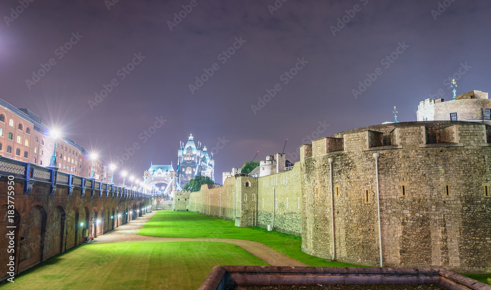 Tower of London and city skyline at night