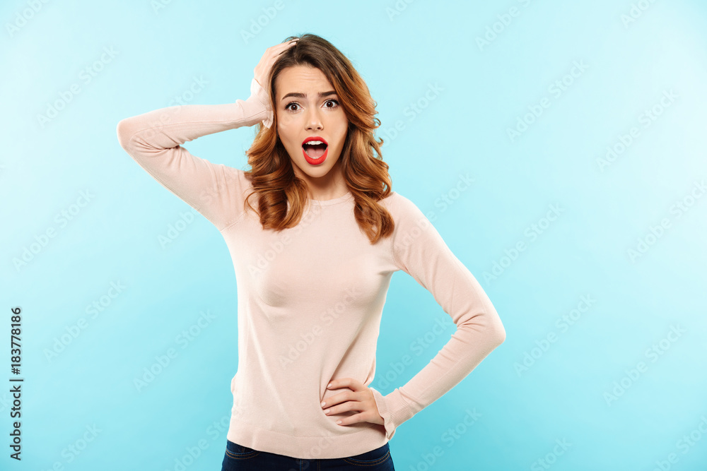Portrait of an excited pretty girl dressed in sweater screaming Portrait of an excited pretty girl dressed in sweater screaming