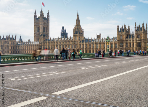 LONDON - SEPTEMBER 29, 2013: Tourists on Westminster Bridge. London attracts 30 million visitors every year