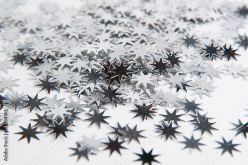 closeup of star confetti on a white background
