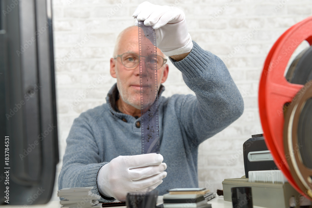 custom made wallpaper toronto digitalman photographer looking at negative film