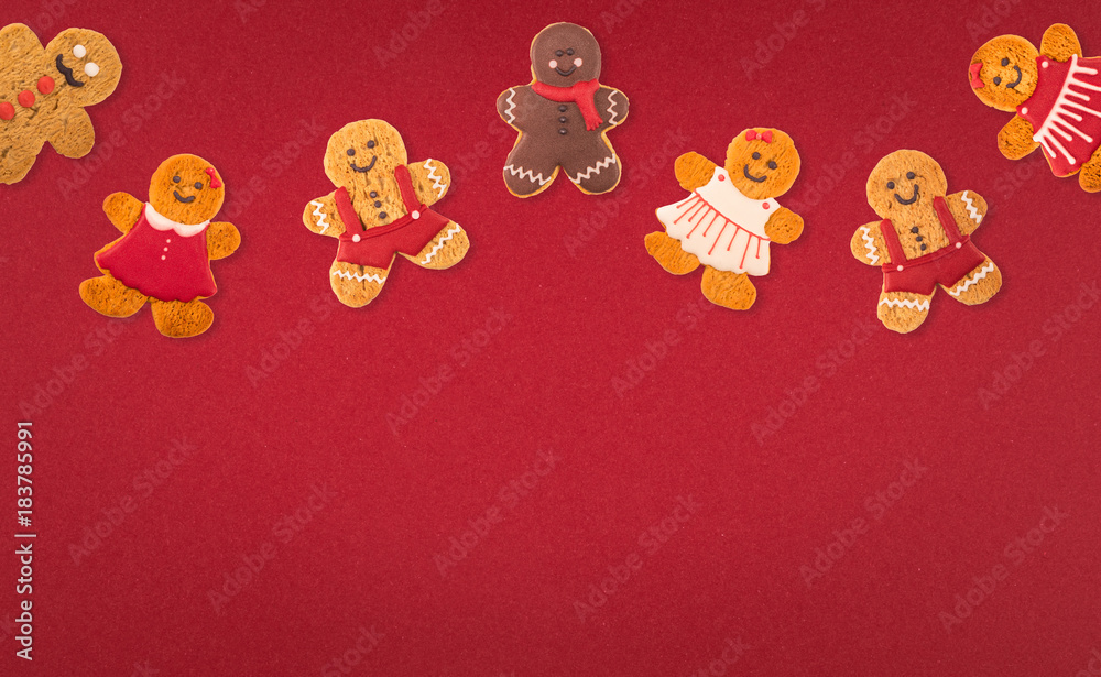 Christmas cookies of different shapes and sizes with a festive decor on a red background. Holiday Poster concept. Empty place for a postural inscription Christmas cookies of different shapes and sizes with a festive decor on a red background. Holiday Poster concept. Empty place for a postural inscription