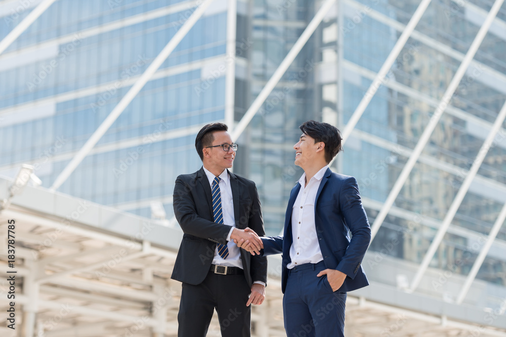businessman being handshaking. in the background of city building office. Business deals concept. businessman being handshaking. in the background of city building office. Business deals concept.