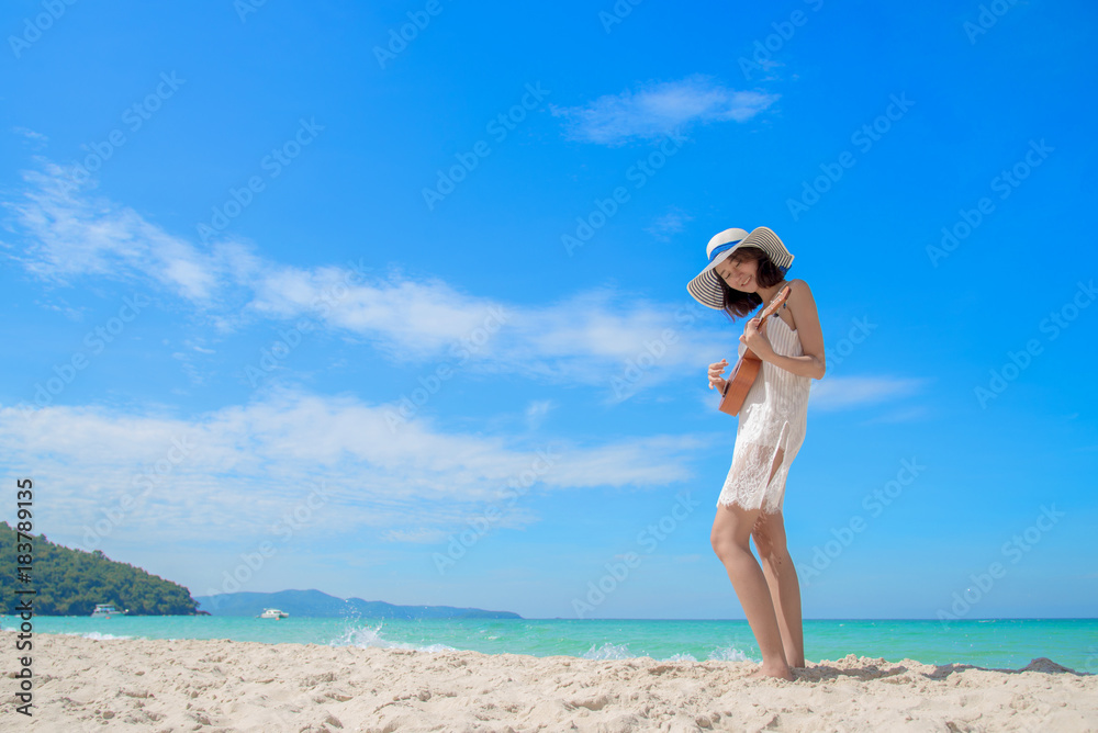 cute woman enjoy playing ukulele on the sea beach at sunny brightday blue sky cute woman enjoy playing ukulele on the sea beach at sunny brightday blue sky