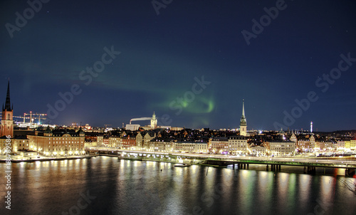 Scenic night panorama of the Stockholm, Sweden with visible northern lights