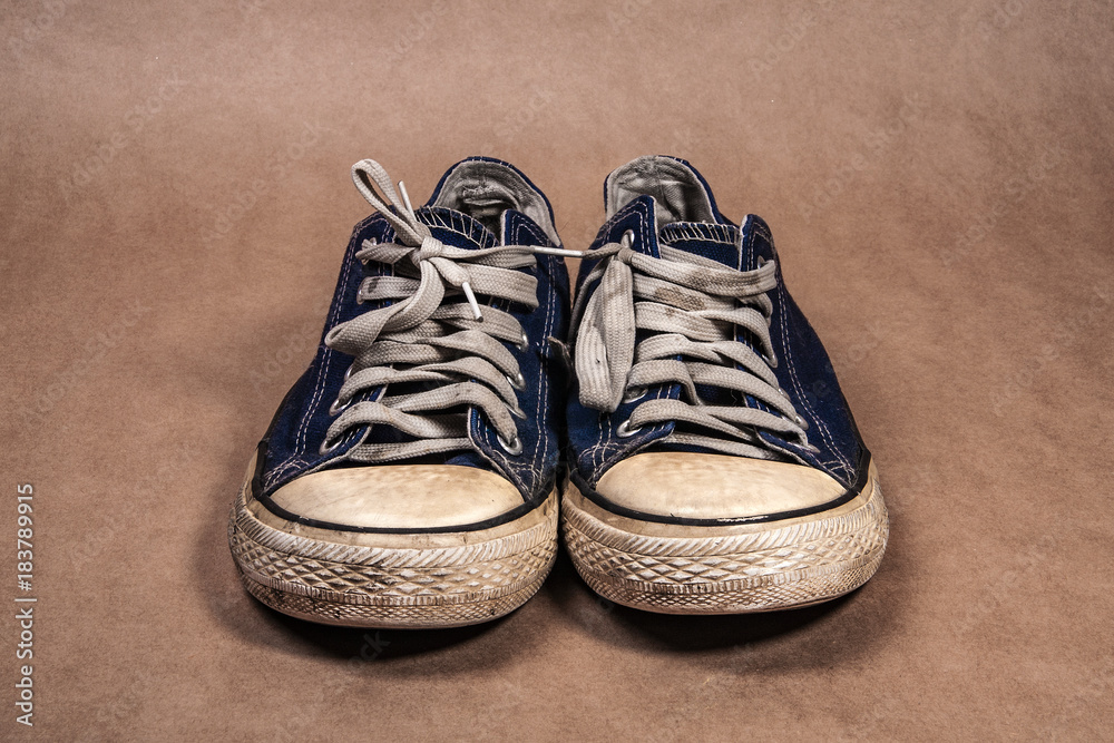 old dirty sneakers on a kraft background