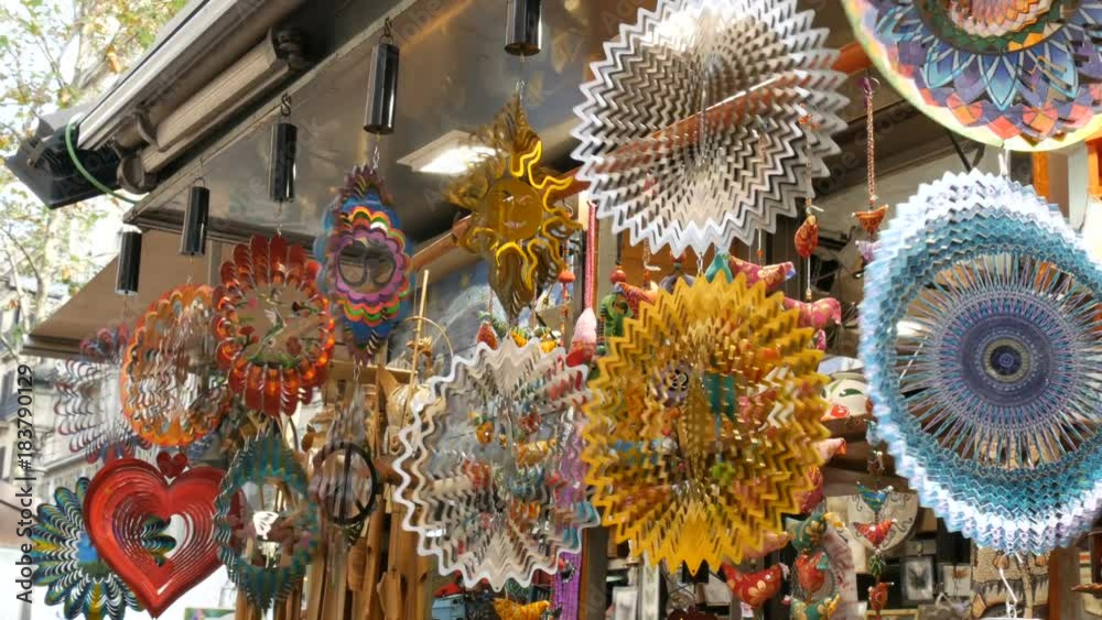 BARCELONA, SPAIN, SEPTEMBER 22 2017: a windmill kinetic sculptures sway from the wind on the counter of a souvenir shop on the Rambla street