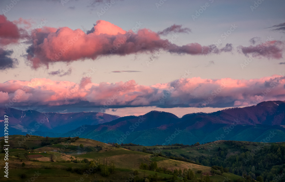 mountain ridge under the pink sky at dawn. lovely springtime landscape