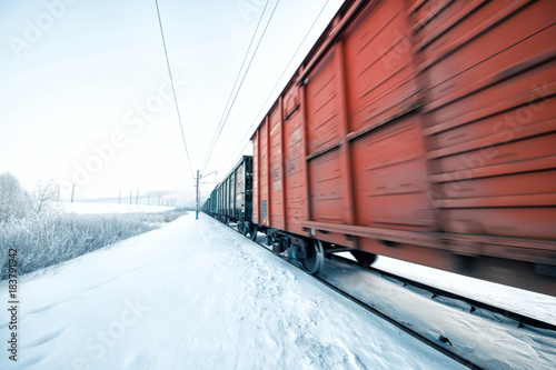 Winter railway and train with cargo.
